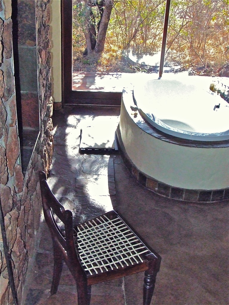 Indoor bathtub overlooking private suite deck